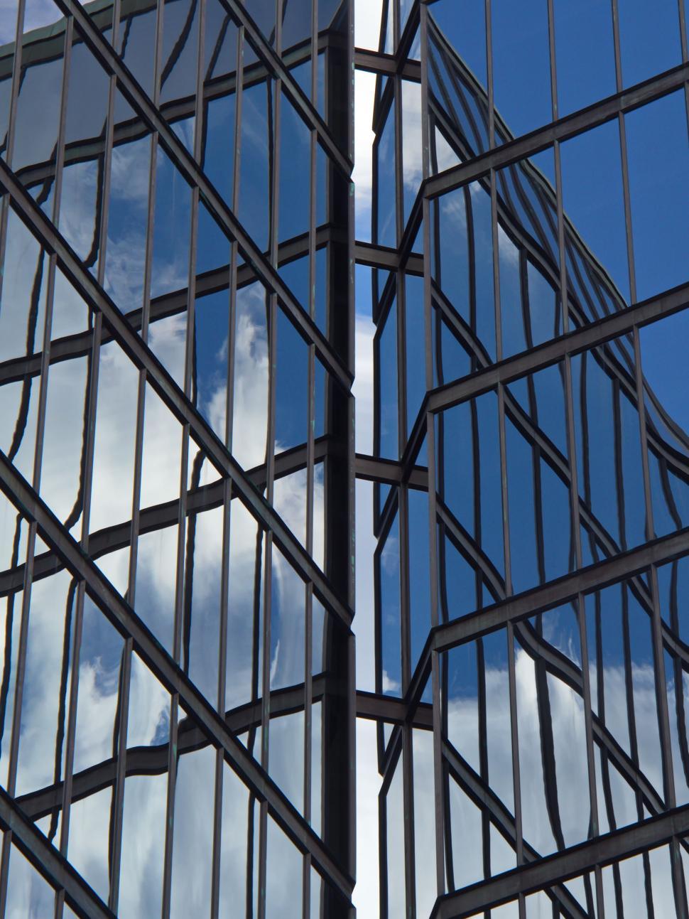 Free Image of Modern Glass Building with Cloud Reflections 