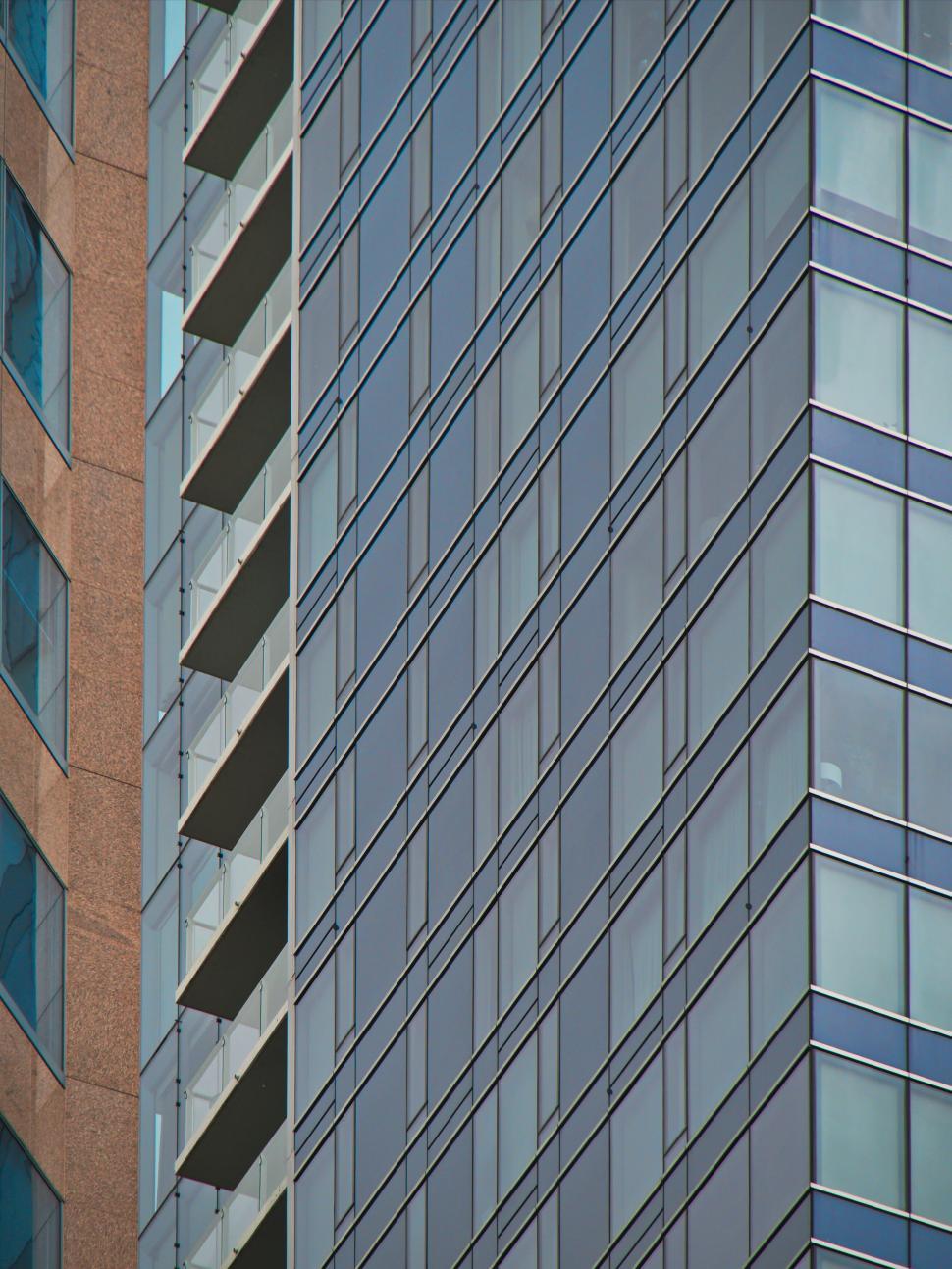 Free Image of Modern glass building with balconies and sleek design 