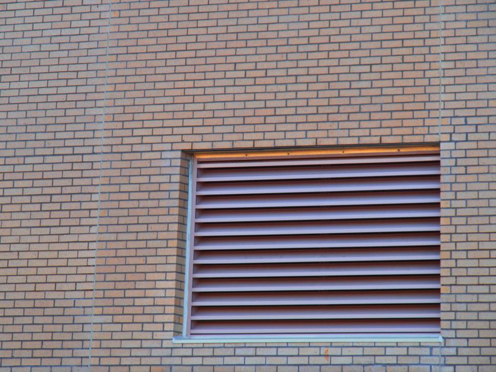 Free Image of Ventilation window on a brick wall of a building 