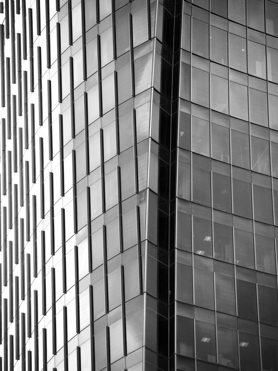 Free Image of Modern glass building with reflective windows in black white 