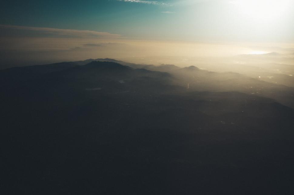 Free Image of Distant mountains and valleys under the setting sun 