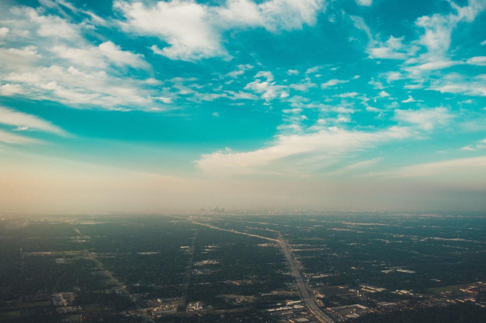 Free Image of Aerial view of a sprawling landscape under a cloudy sky. 