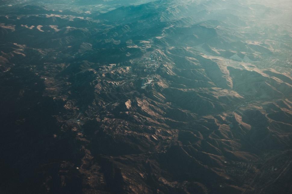Free Image of Aerial view of rugged mountain landscape at sunrise. 