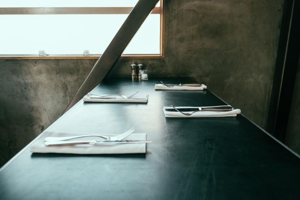 Free Image of Minimalist table setting in an industrial-style cafe. 