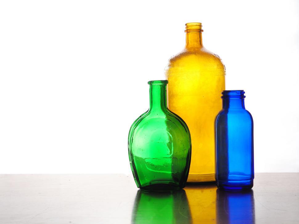 Free Image of Colorful glass bottles against a white background 