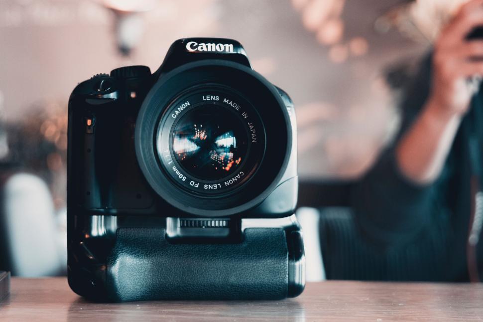 Free Image of Canon camera on a table with background out of focus 