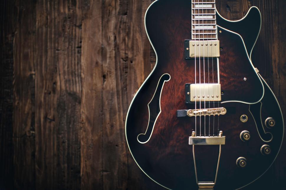 Free Image of Close up of an elegant electric guitar on a wooden background. 