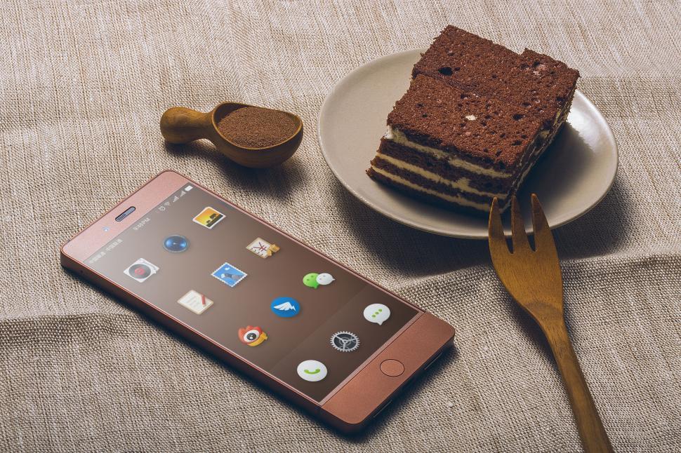 Free Image of Smartphone with cake slice and powder on table. 