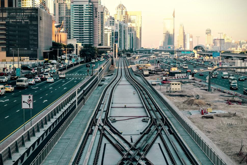 Free Image of Cityscape with train tracks and highway, modern skyline. 