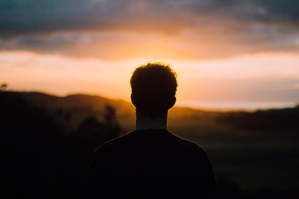 Free Image of Contemplative silhouette of a lone person at sunset 