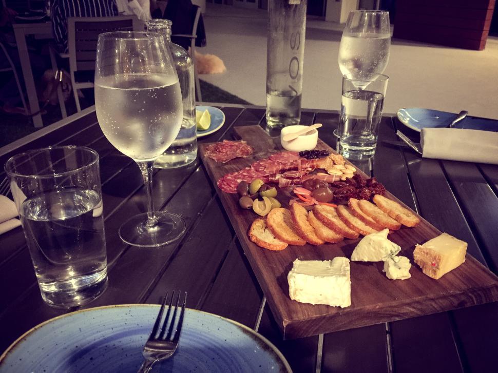 Free Image of Elegant dining setup with a charcuterie board and water. 