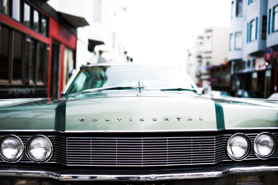 Free Image of Classic car front view in the city with buildings visible 