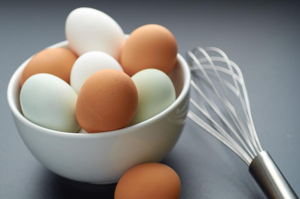 Free Image of A bowl filled with brown, white, and blue eggs. 