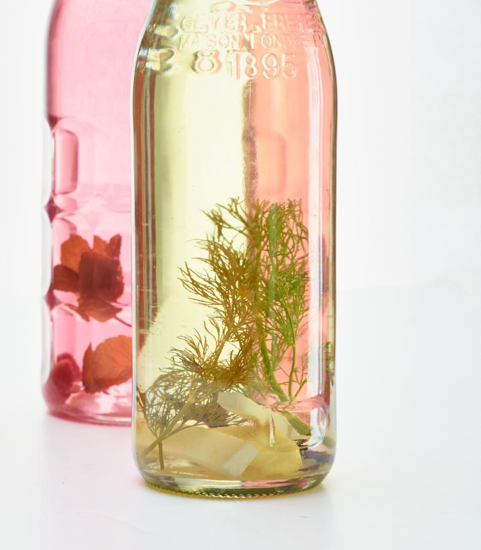 Free Image of Decorative bottles with pink and yellow liquid designs 