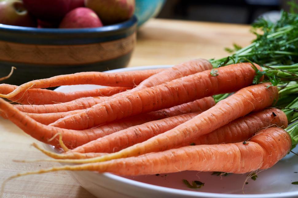 Free Image of Freshly harvested orange carrots placed on a white dish 