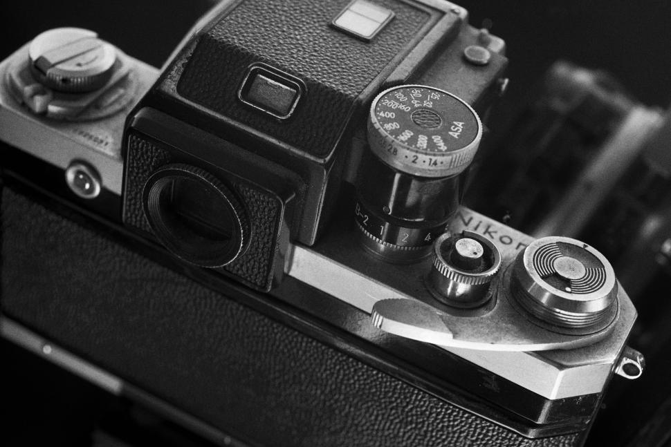 Free Image of Black and white vintage Nikon camera on a dark surface 