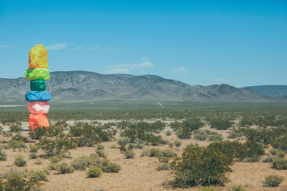 Free Image of Colorful rock formation in a vast desert landscape view 
