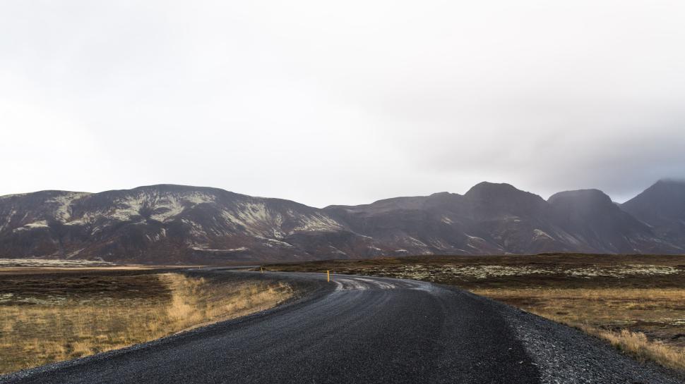 Free Image of Empty winding road through a barren mountainous region. 