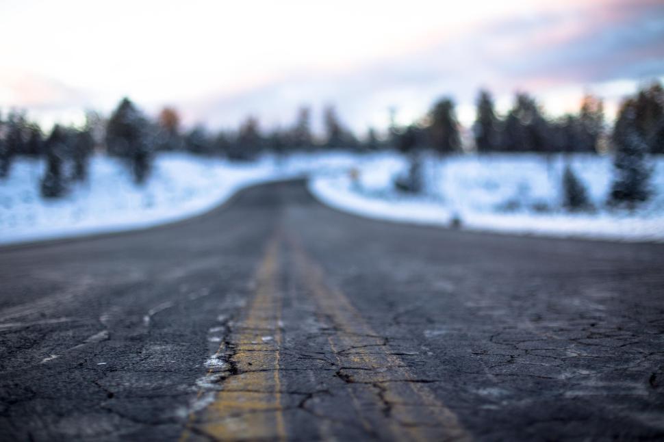 Free Image of Empty road leading towards horizon on snowy landscape. 