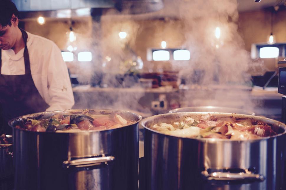 Free Image of Chef cooking large pots with steaming delicious food 