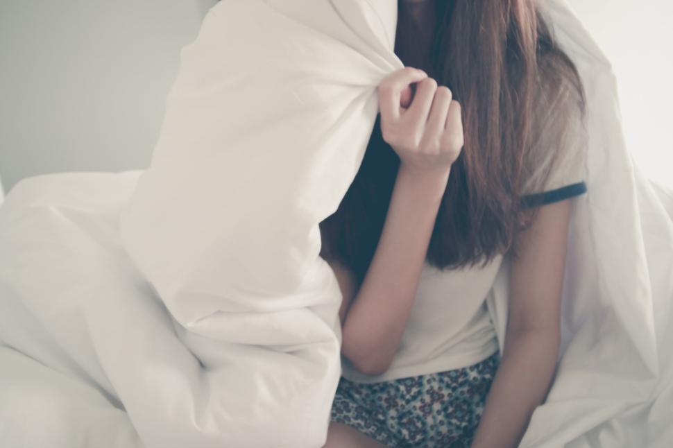 young-woman-relaxing-in-bed-with-white-blanket-cover..jpg