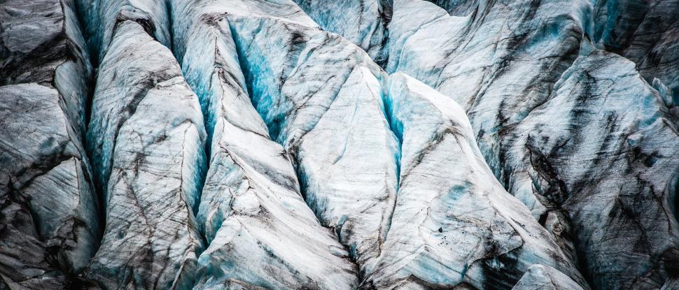 Free Image of Close-up of glacier ice with textures and cracks visible 