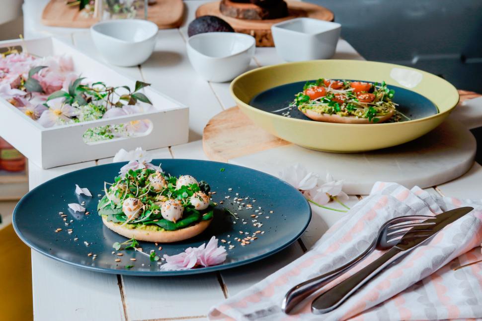 Free Image of Healthy vegetable dishes with tomatoes and greens on table 