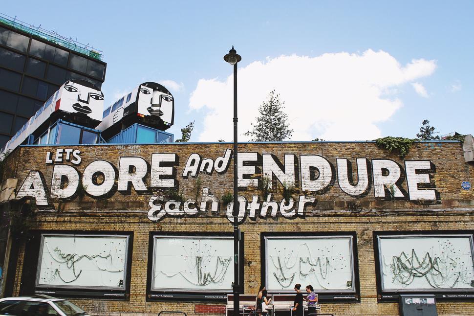 Free Image of Street art mural with motivational phrase on brick wall. 