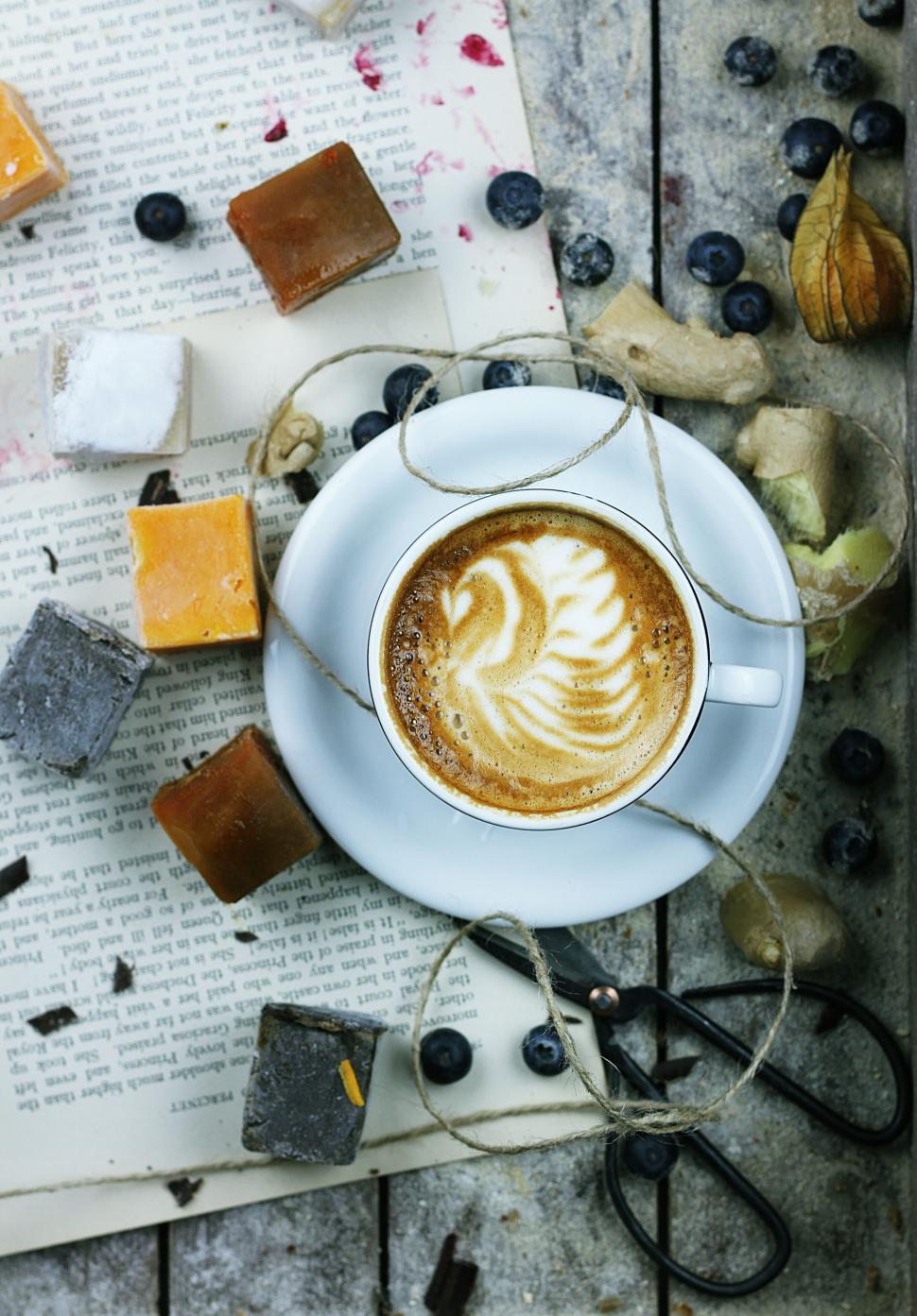 Free Image of Cappuccino with assorted sweets on rustic wooden table. 