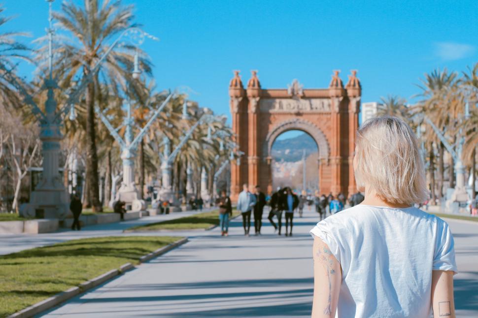 Free Image of Traveler walking towards famous arch on sunny day. 
