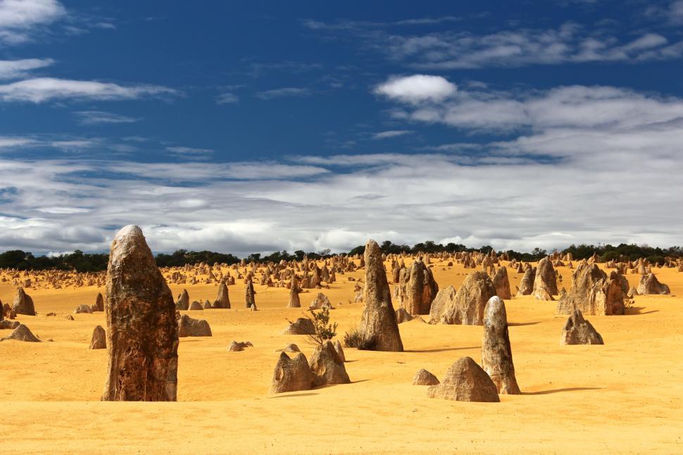Free Image of Desert landscape with unique rock formations and sky 