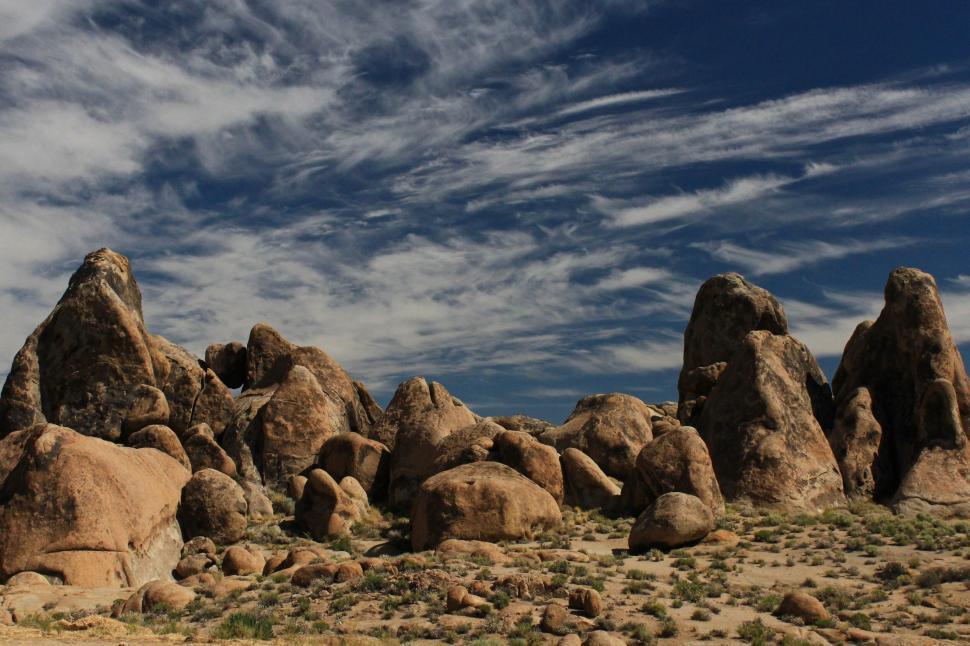 Free Image of Large rock formations under cloudy sky 