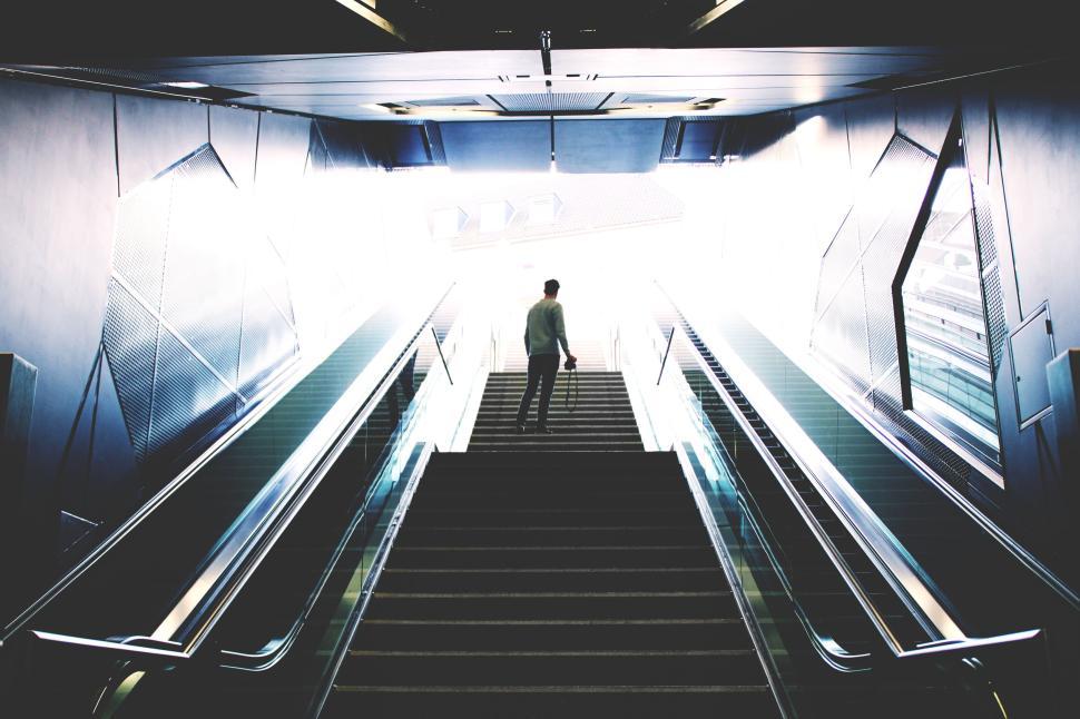 Free Image of Person ascending wide staircase with bright architecture 