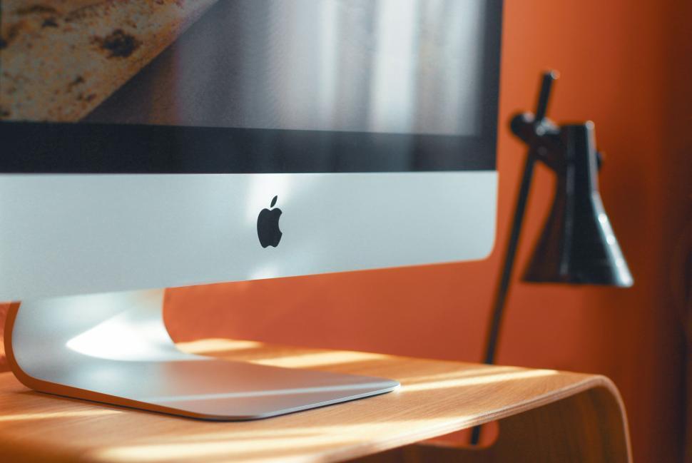 Free Image of Modern computer screen on wooden desk with lamp nearby 