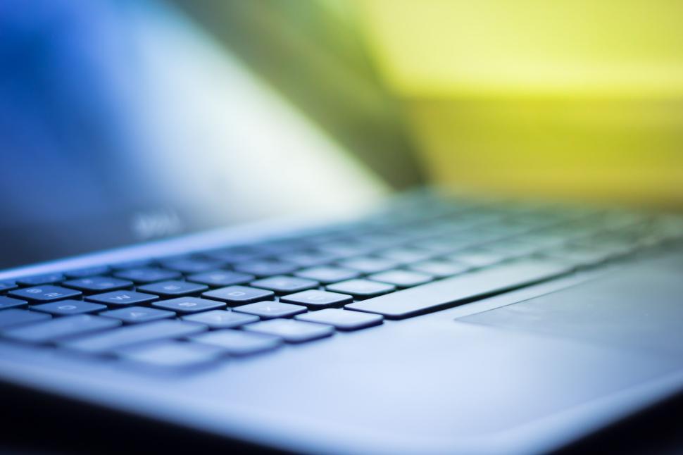 Free Image of Close-up of laptop keyboard and screen with sunlight 