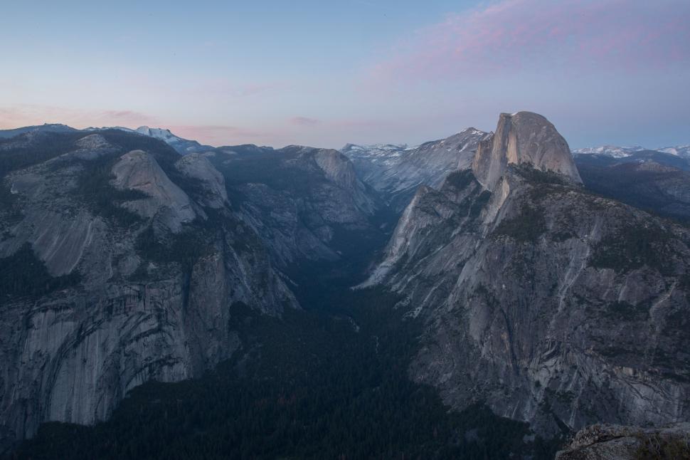Free Image of Vast mountain vista with sunlight on rock faces. 