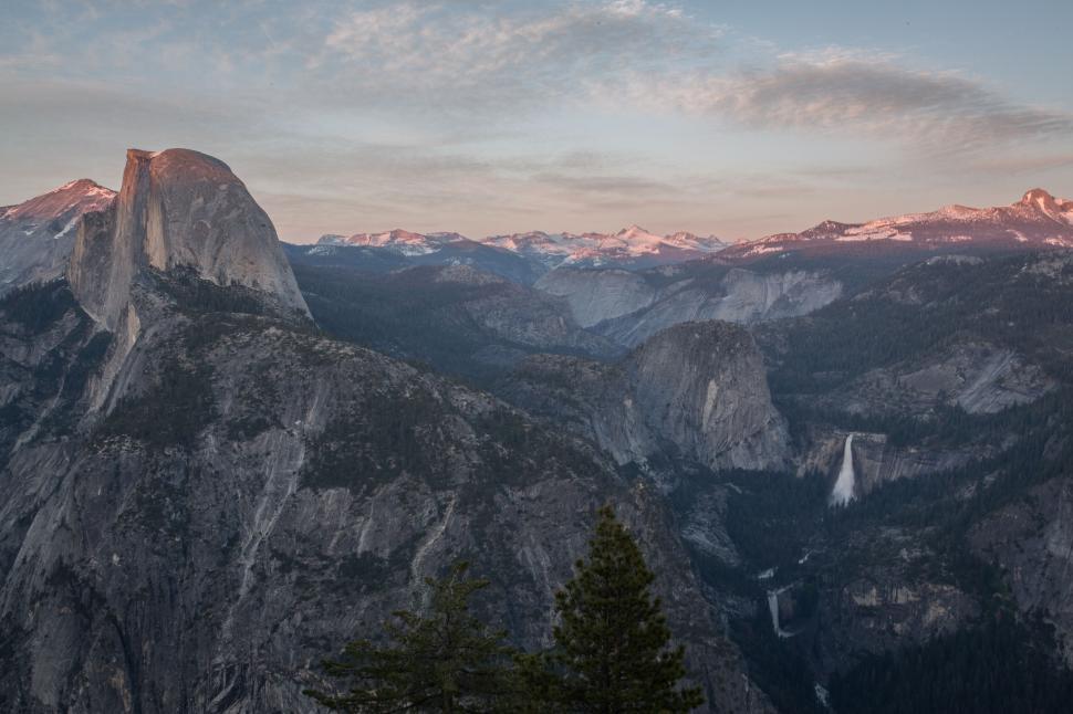 Free Image of Mountain range at twilight with distant waterfalls. 
