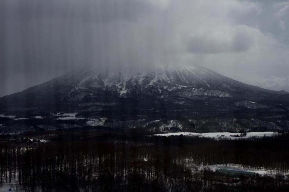 Free Image of Misty mountain with snow-covered peak looming large. 
