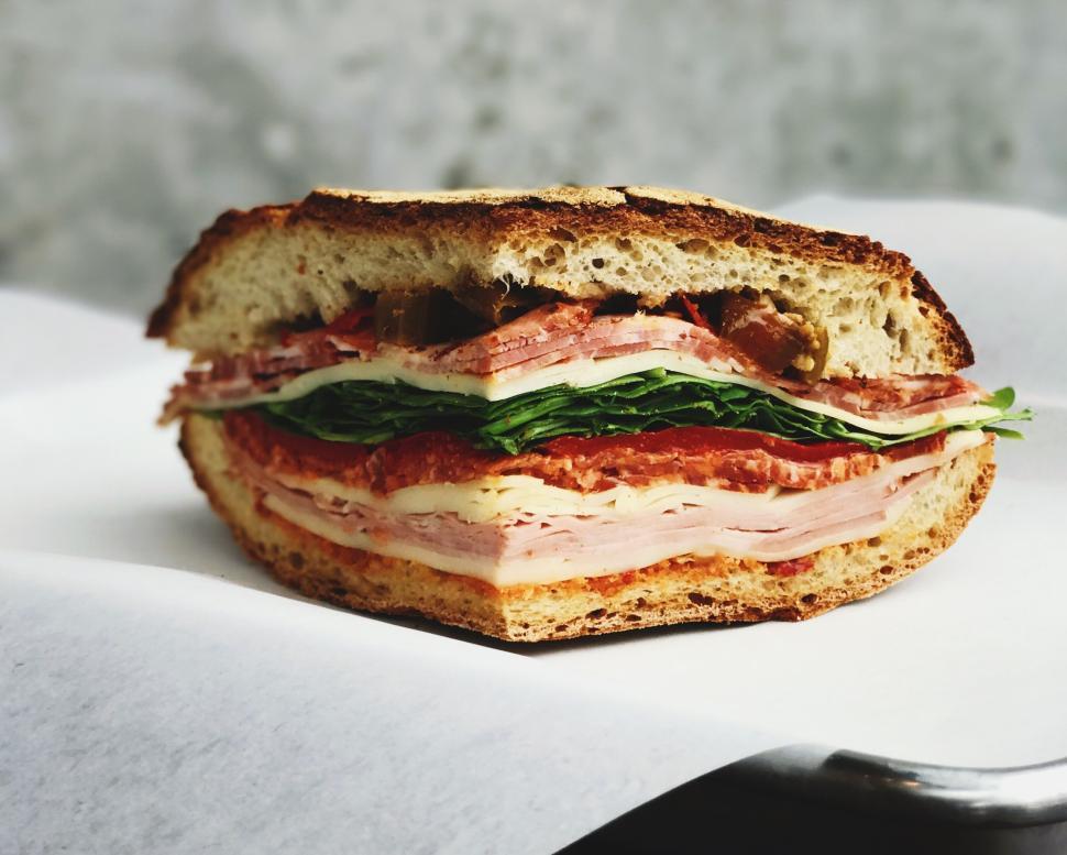 Free Image of Thick savory sandwich filled with layers of fresh ingredients 