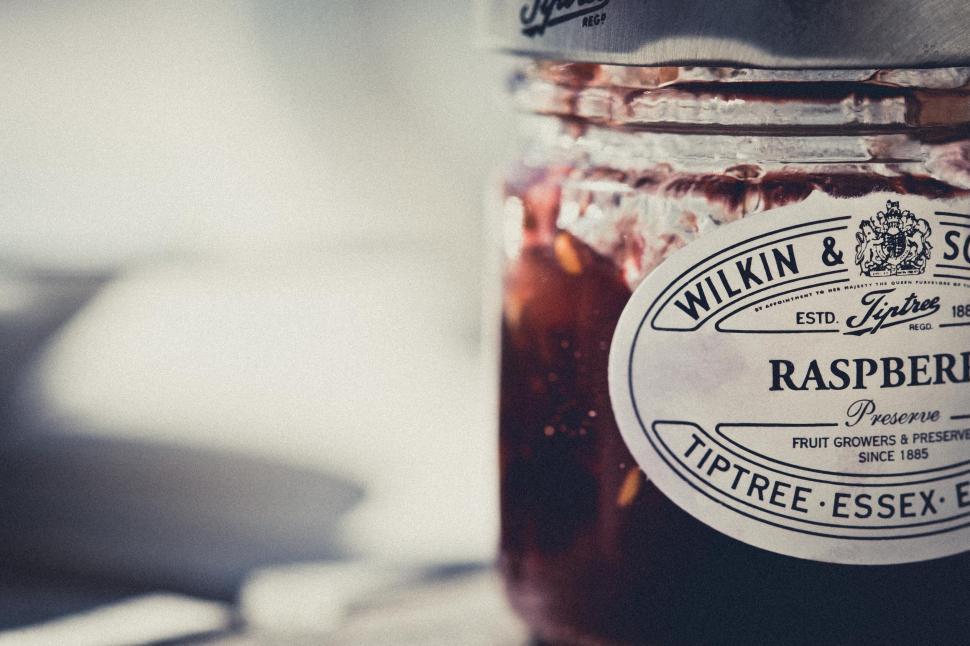Free Image of Close-up of raspberry preserve jar with vintage label. 