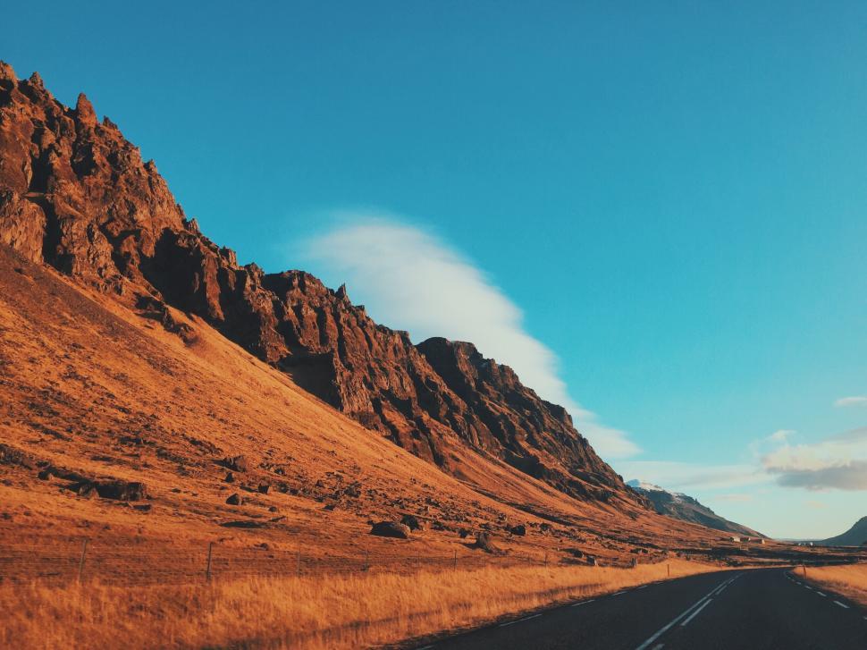 Free Image of Rocky landscape under a clear blue sky on a sunny day 