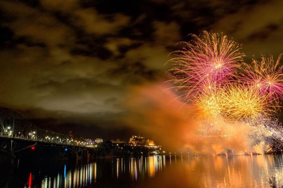 Free Image of Colorful fireworks display over tranquil water at night. 