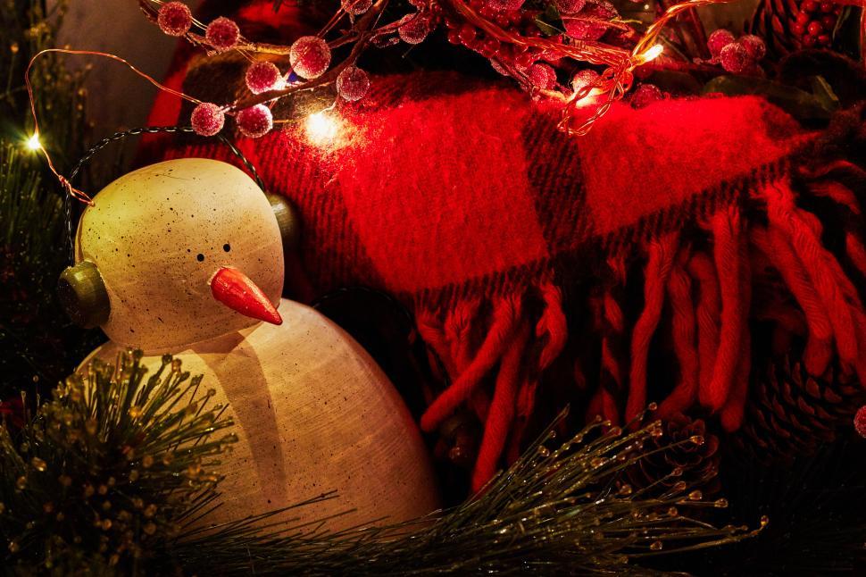 Free Image of Festive decor with wooden snowman and red blanket scene. 