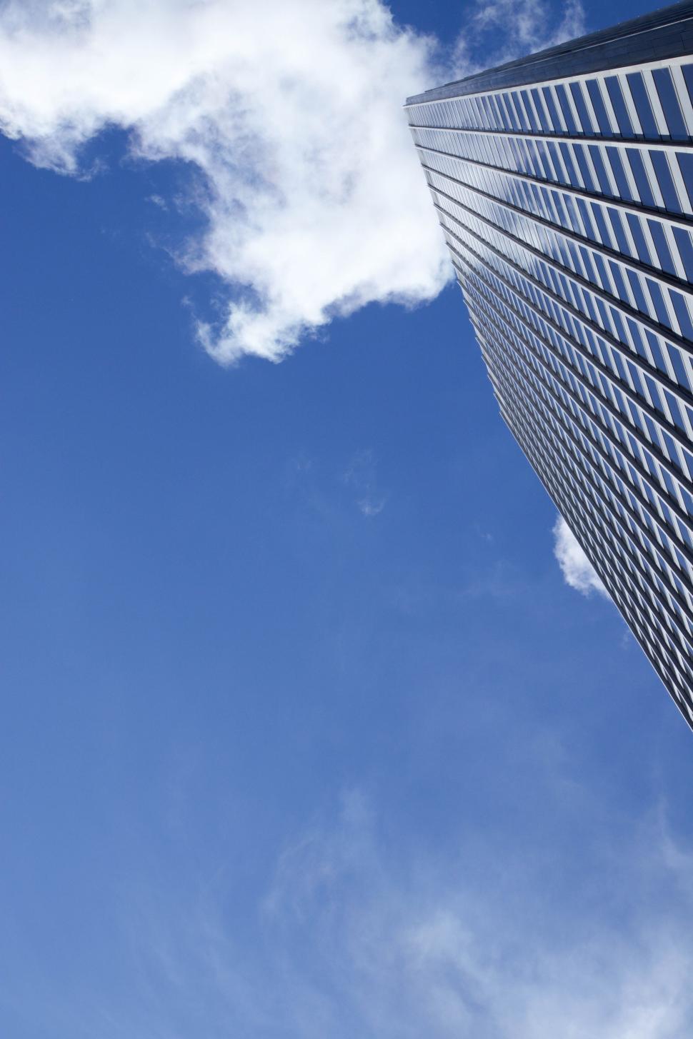 Free Image of Skyscraper reaching into the blue cloudy sky 