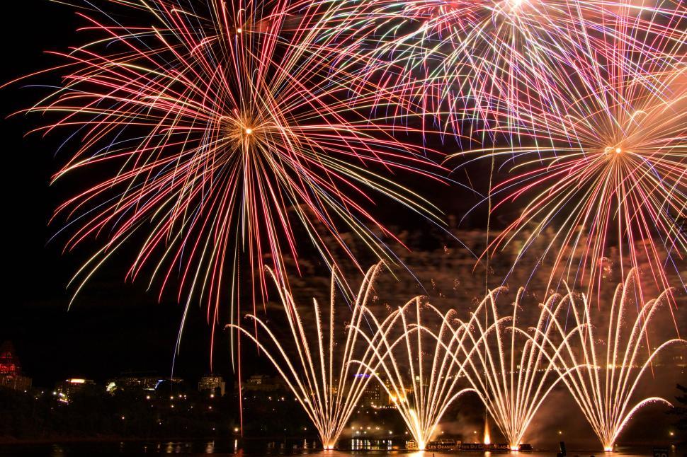 Free Image of Colorful fireworks and golden yellow flares at night. 