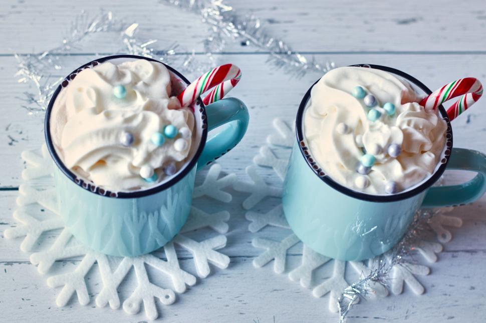 Free Image of Two hot chocolate cups with whipped cream and candy canes 