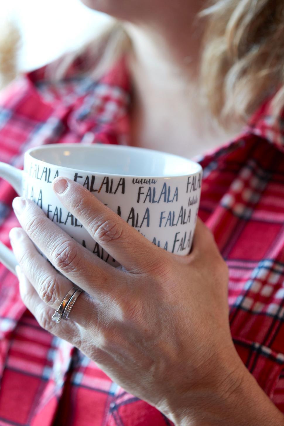 Free Image of Cozy woman in plaid with holiday mug in her hands 