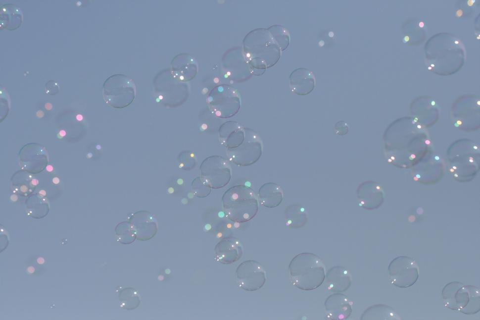 Free Image of Floating soap bubbles against a clear blue sky. 