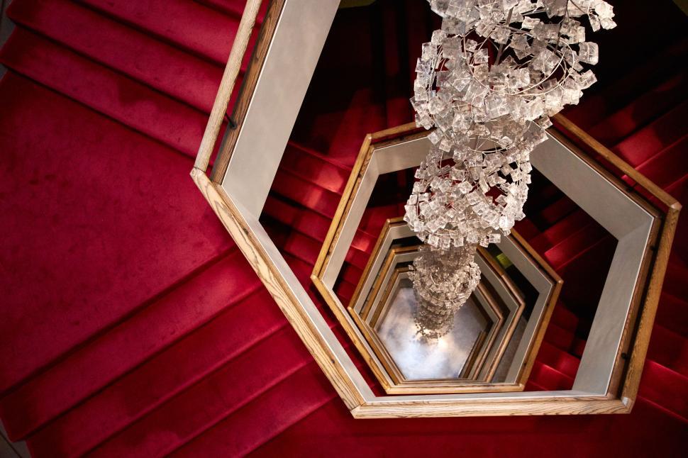 Free Image of Hexagonal red staircase with chandelier vertical view 