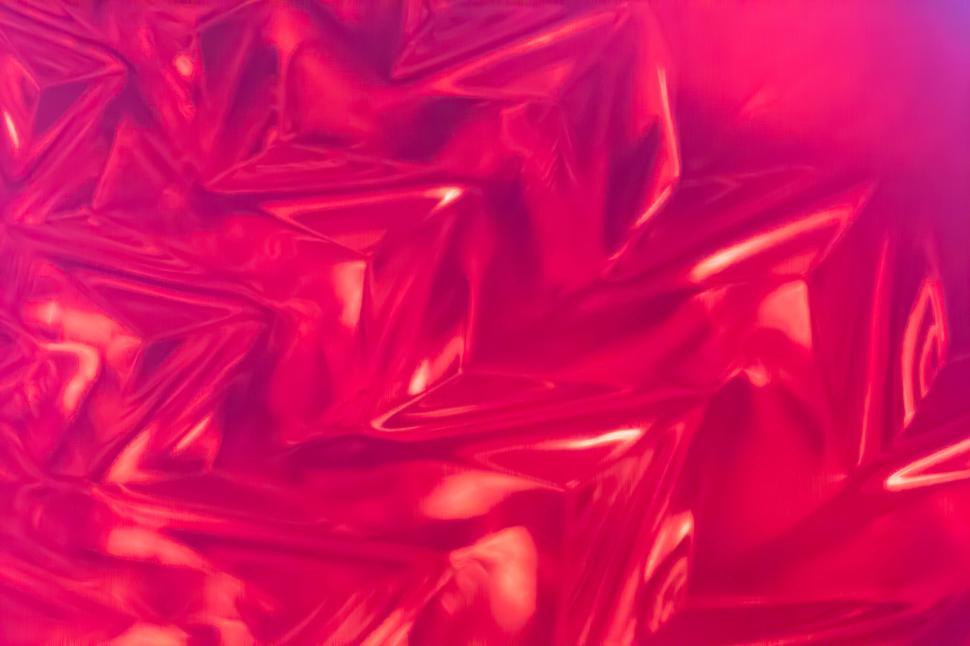 Free Image of Red crumpled foil creating abstract patterns 
